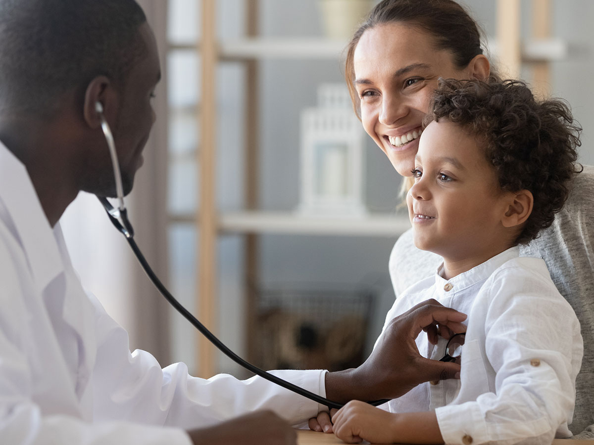 One Marketing - Client Kemptville District Hospital - Black doctor helping a young mother and her son at a doctors appointment